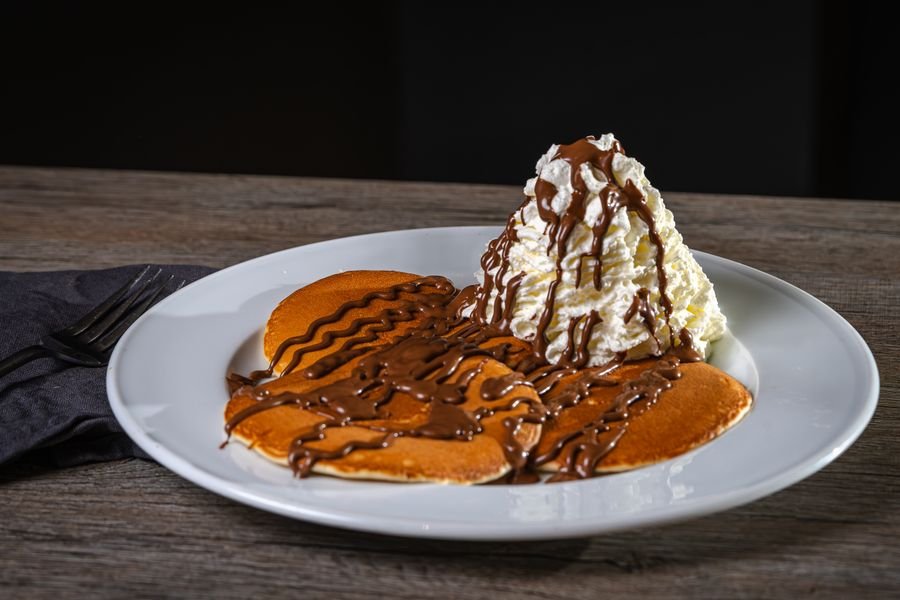 Pancakes with chocolate sauce and whipped cream